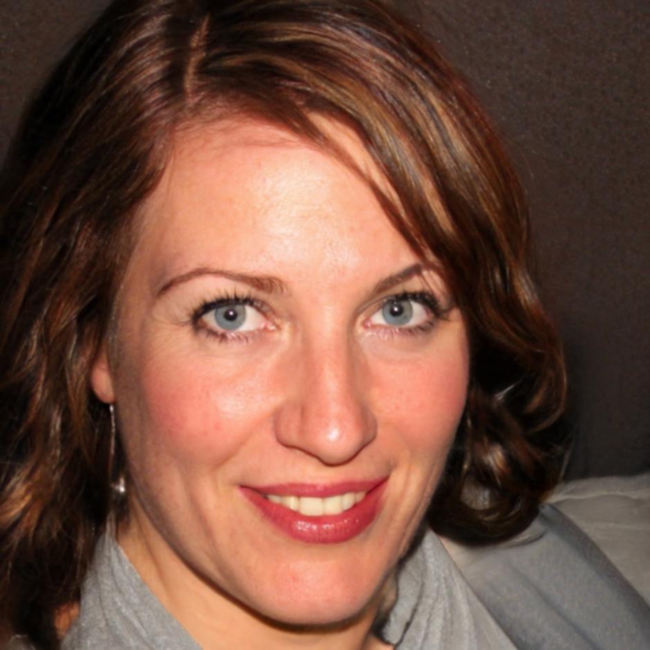 Professional woman in business attire smiling at camera